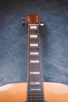 acoustic guitar on blue marble background,music concept.