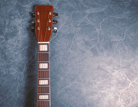 acoustic guitar neck on blue marble background,music concept.