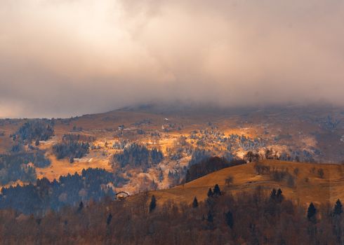 awesome view of the Orobie Alps, autumn / winter, the mountain is a little snow-covered ,the grass is burned by the cold and turns orange.Oltre il Colle,north alps,Seriana Valley,Bergamo Italy.