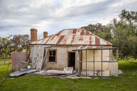 Old abandoned farm house neglected and falling into ruin as time passes