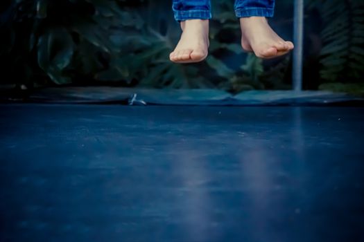 Legs floating in the air after jumping on the trampoline.
