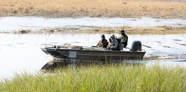 Tourists on a motorboat, on their way to spot hippo's - Botswana