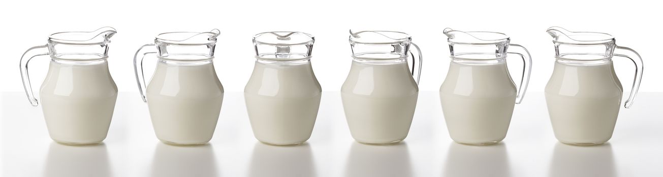 Glass jug of milk isolated on white background, cream or milk pitcher, collection