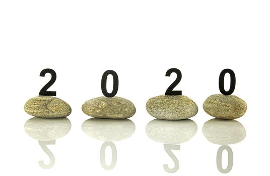 New years resolution 2020 concept, Wooden year number on stones isolated on white background with reflection and copy space