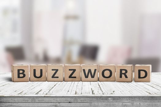 Buzzword made of wooden blocks on a table in a bright room in daylight