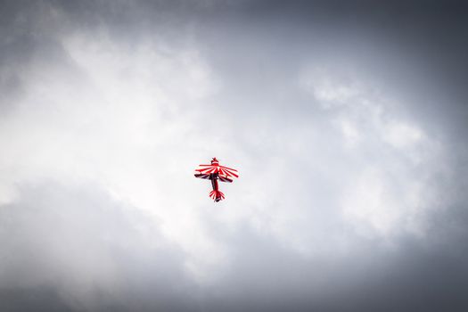 Airplane flying up in cloudy weather trying to make a loop