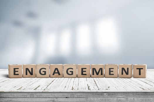 Engagment sign made of wooden blocks on a table in bright room with windows
