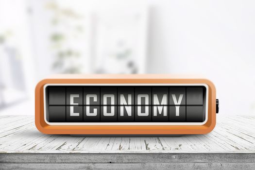 Economy word on an analog device in a bright home on a wooden desk