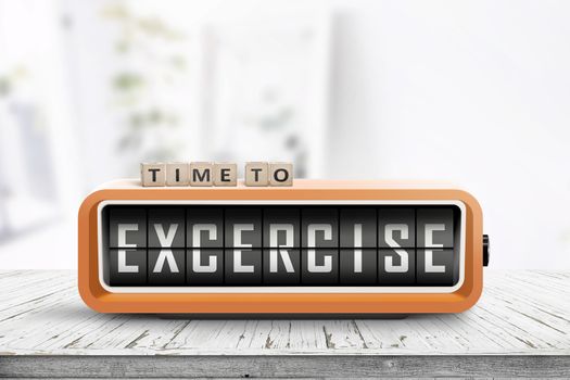 Time to excercise message on an alarm clock in a bright living room on a wooden table