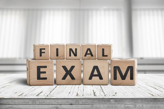 Final exam sign in a bright education room on a wooden table