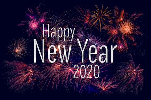 Happy New Year 2020 greeting with colorful fireworks in the night sky