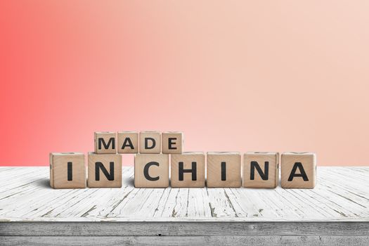 Made in China sign on a wooden desk with a red wall in the background