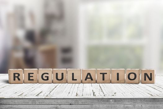 Regulation sign on a wooden table in a bright offive in daylight