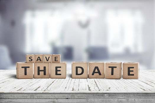 Save the date memo sign on a wooden table in a cozy bright room
