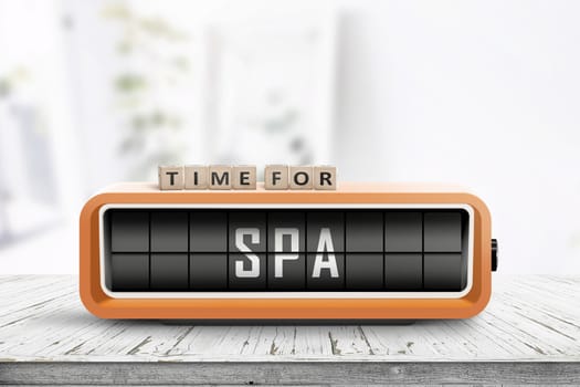 Time for spa message on a colorful alarm clock in a bright room with a wooden table