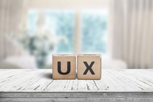 UX development sign on a table in a bright room with cyan colors