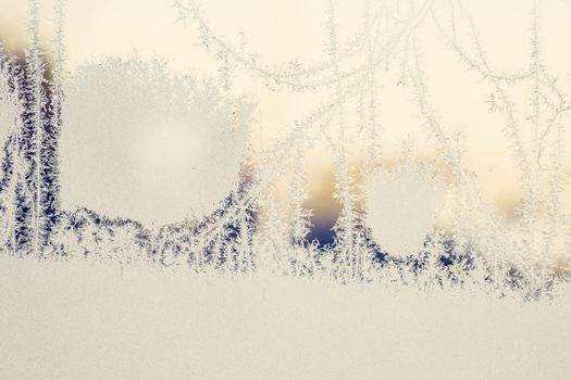 Frozen ice on a window in the sunrise on a December morning