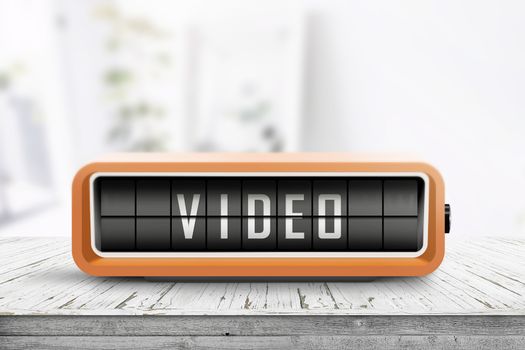 Video message on a retro alarm clock in a bright room on a wooden table