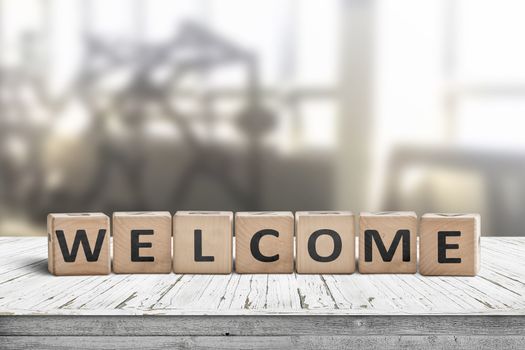 Welcome sign on a table in a lobby with a bright room in the background