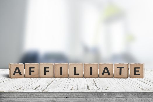 Affiliate marketing sign on a wooden desk with a blurry office environment in the background