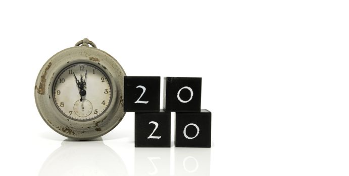 2020 New Years eve celebration. Minutes to midnight on an old watch isolated on white background