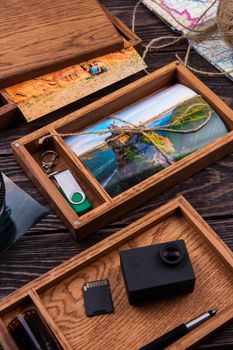 Wooden photo box with photo from travel. Decorated with different things. Travel concept.