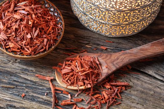 Red sandalwood chips on a spoon