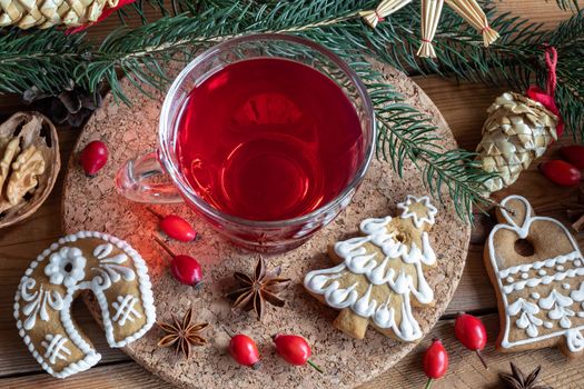 A cup of rose hip tea with Christmas gingerbread cookies