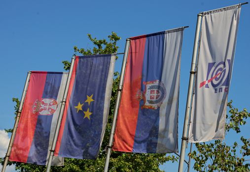 Serbian and Vojvodina and Electric company waving on pillar