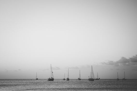 Soft and calm image of little recreational boats anchored in Hanalei Bay, Kauai, US