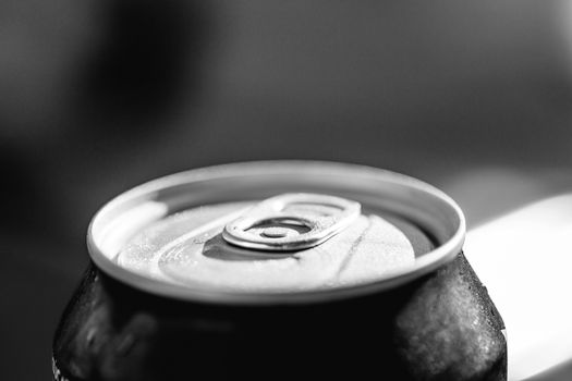 Close-up view on the top of a closed blue can drink with condensation.