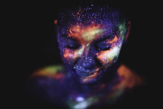 Conceptual shot of light and shine fluorescent colors young girl's face