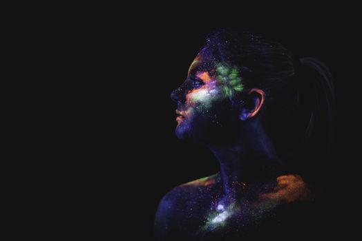 Conceptual shot of light and shine fluorescent colors young girl's face