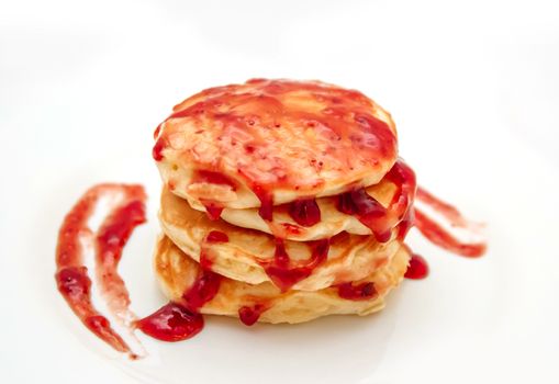 Pancakes with strawberry jam white plate. Selective focus
