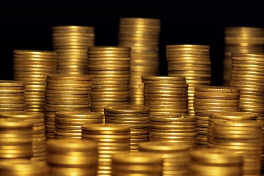 A lot of coins, selective focus.Front view of stacks of Euro coins.Concept photo.Coins close-up on the table. Simple and minimalistic design .