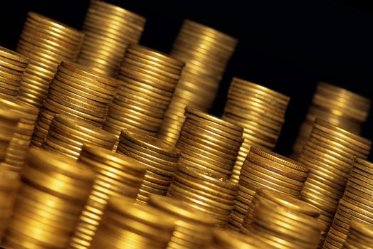 A lot of coins, selective focus.Front view of stacks of Euro coins.Concept photo.Coins close-up on the table. Simple and minimalistic design .