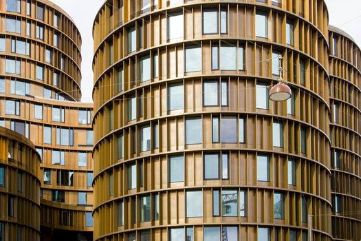 A modern glass and metal building of unusual design with a curved facade.