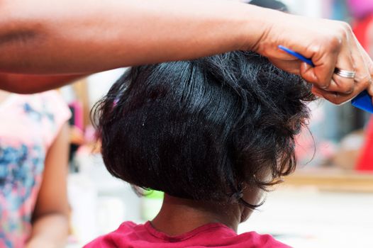 The hairdresser creates a model of hair on the head of her clent. 