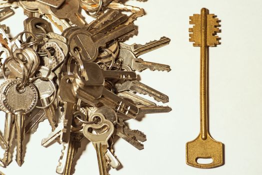 Many keys of different sizes. Keys on a white background, close-up. Selective focus, soft focus.