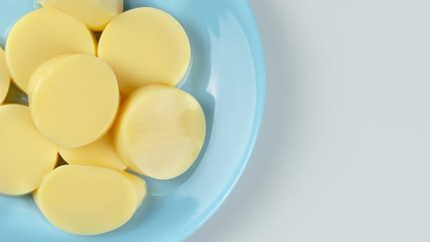 top view egg tofu slices on blue plate on white background