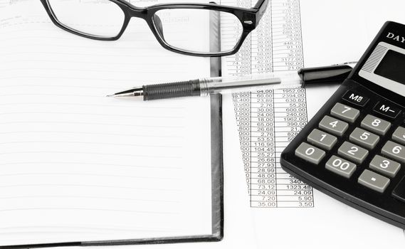 calculator and pen on a business background 