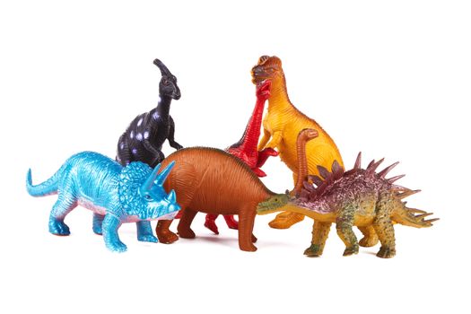 Toy dinosaurs on white background 