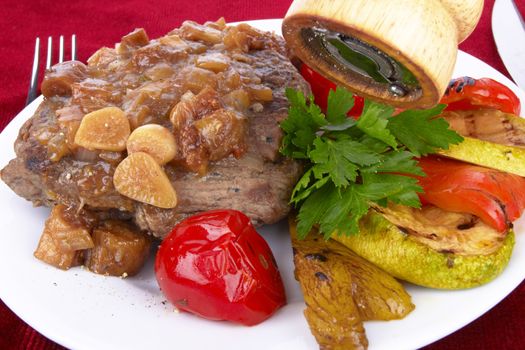 Grilled steak meat with vegetables on a white background