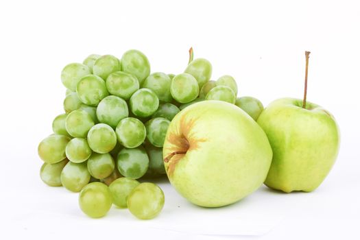 Grapes and two apples on a white background