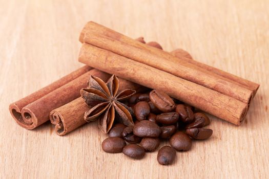 Coffee beans and cinnamon sticks closeup 