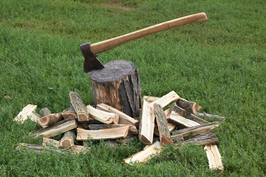 Wooden logs and rusty axe 