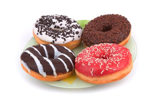 different donuts on a green plate  on white