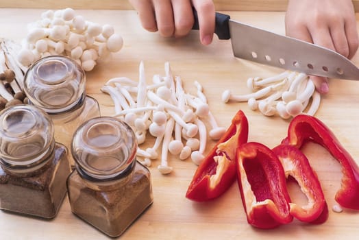 A set of sweet pepper and mushroom ingredients on a wooden boardWhite beech mushrooms or Shimeji mushroom . Small white and brown mushrooms on the table.