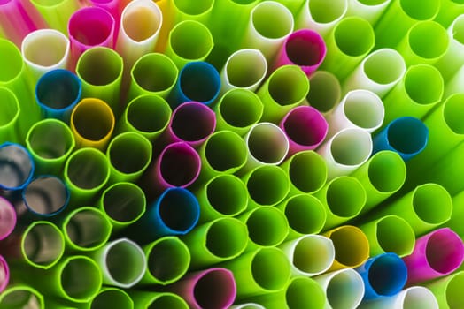 Abstract colorful background. Background from cocktail tubes close up. Soft focus. Cocktail tubes of different colors close up.Close-up of straw tubes.