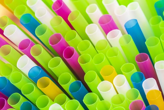 Abstract colorful background. Background from cocktail tubes close up. Soft focus. Cocktail tubes of different colors close up.Close-up of straw tubes.